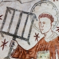 The deacon St. Lawrence holding a gridiron, reminding of his martyrdom. Gothic fresco in Linderod church, Sweden