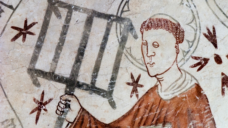 The deacon St. Lawrence holding a gridiron, reminding of his martyrdom. Gothic fresco in Linderod church, Sweden