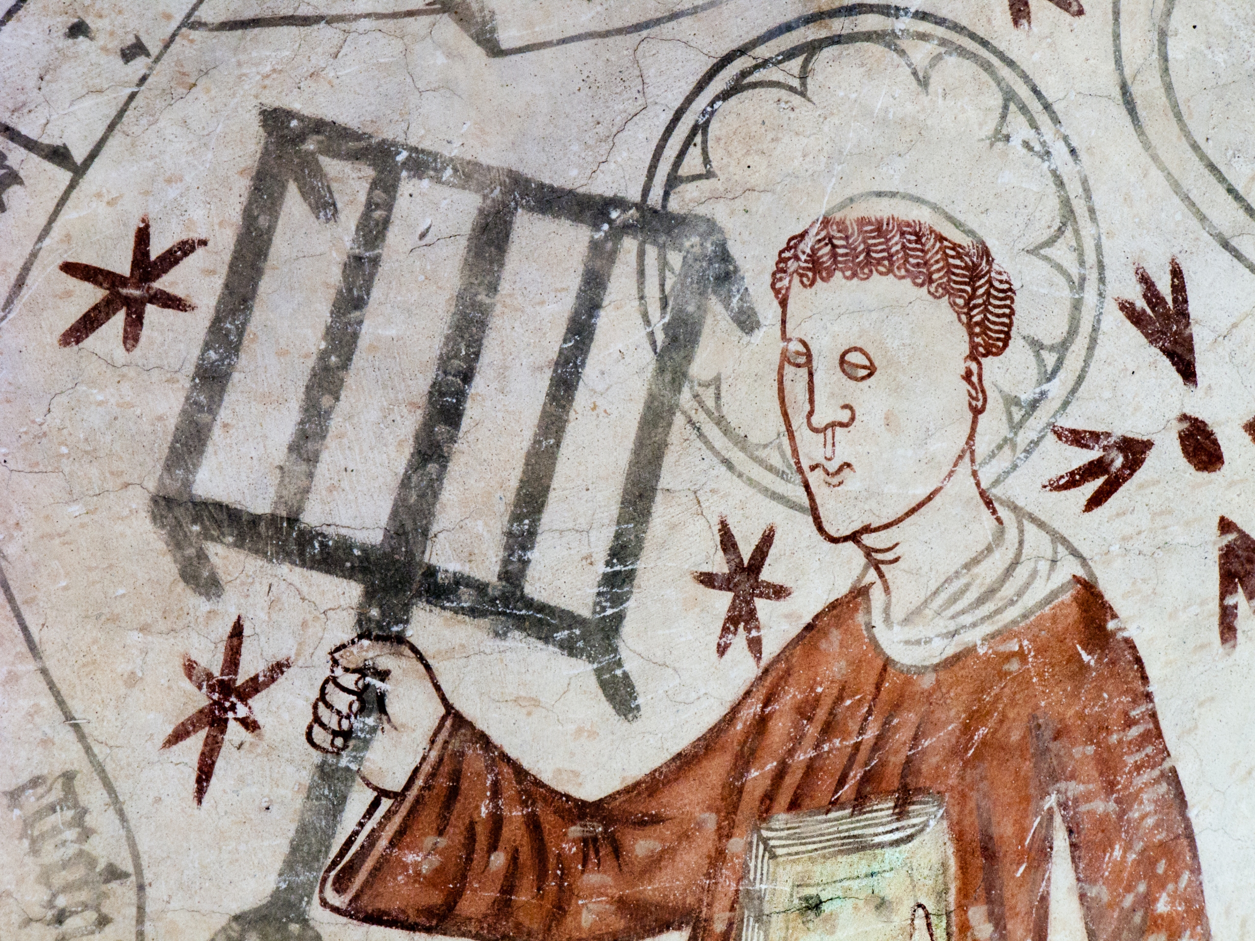 The deacon St. Lawrence holding a gridiron, reminding of his martyrdom. Gothic fresco in Linderod church, Sweden