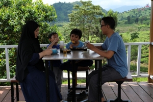 Asian Muslim family enjoying breakfast at a hotel