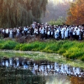 Ultra-Orthodox Jewish Hasids pilgrims pray on a bank of a lake near the tomb of Rabbi Nachman of Breslov