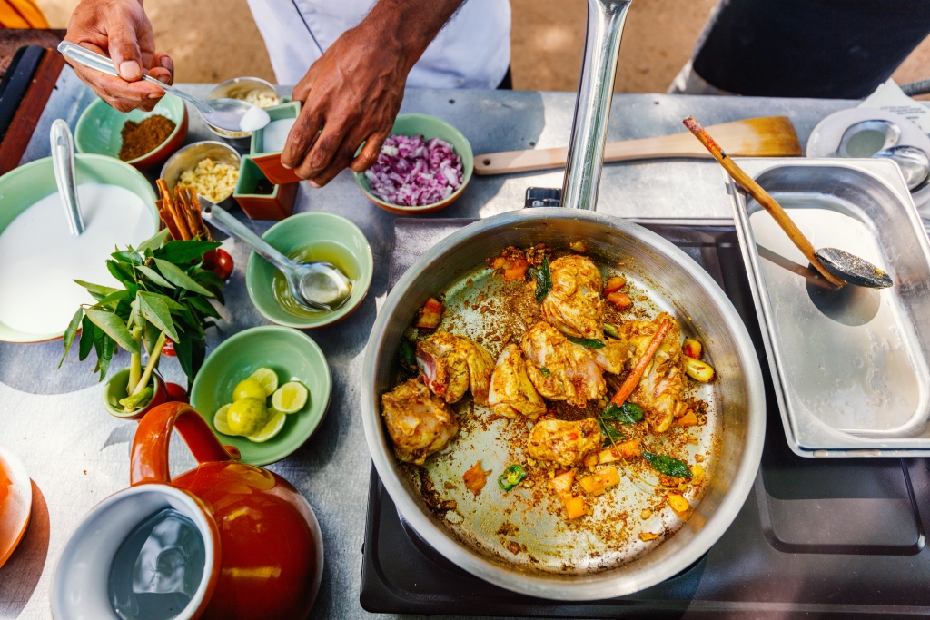 Preparing a traditional Sri Lankan curry dish with tender chicken breast