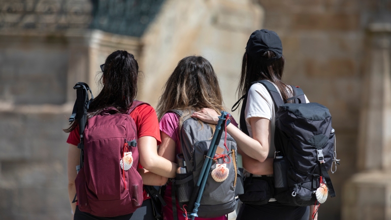 Pilgrims on the Camino de Santiago arrive at the Plaza del Obradoiro