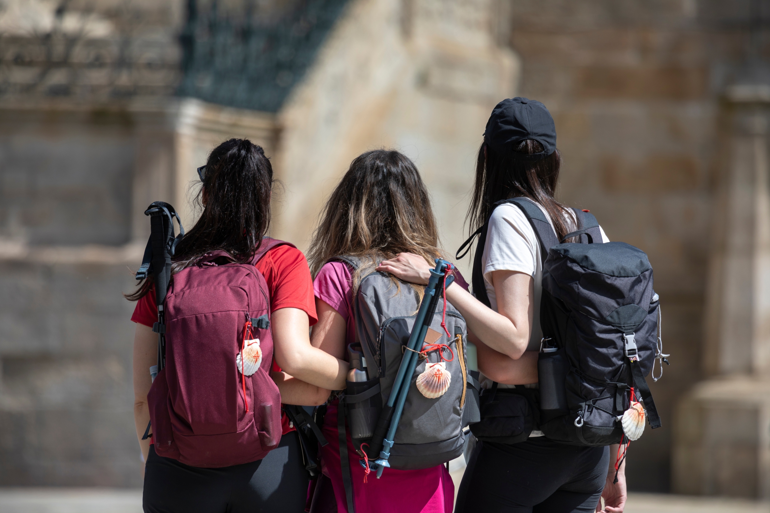 Pilgrims on the Camino de Santiago arrive at the Plaza del Obradoiro