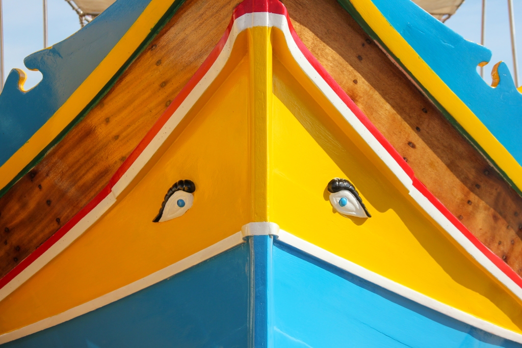 Traditional painted eyed boats luzzu in fishing village Marsaxlokk, Malta