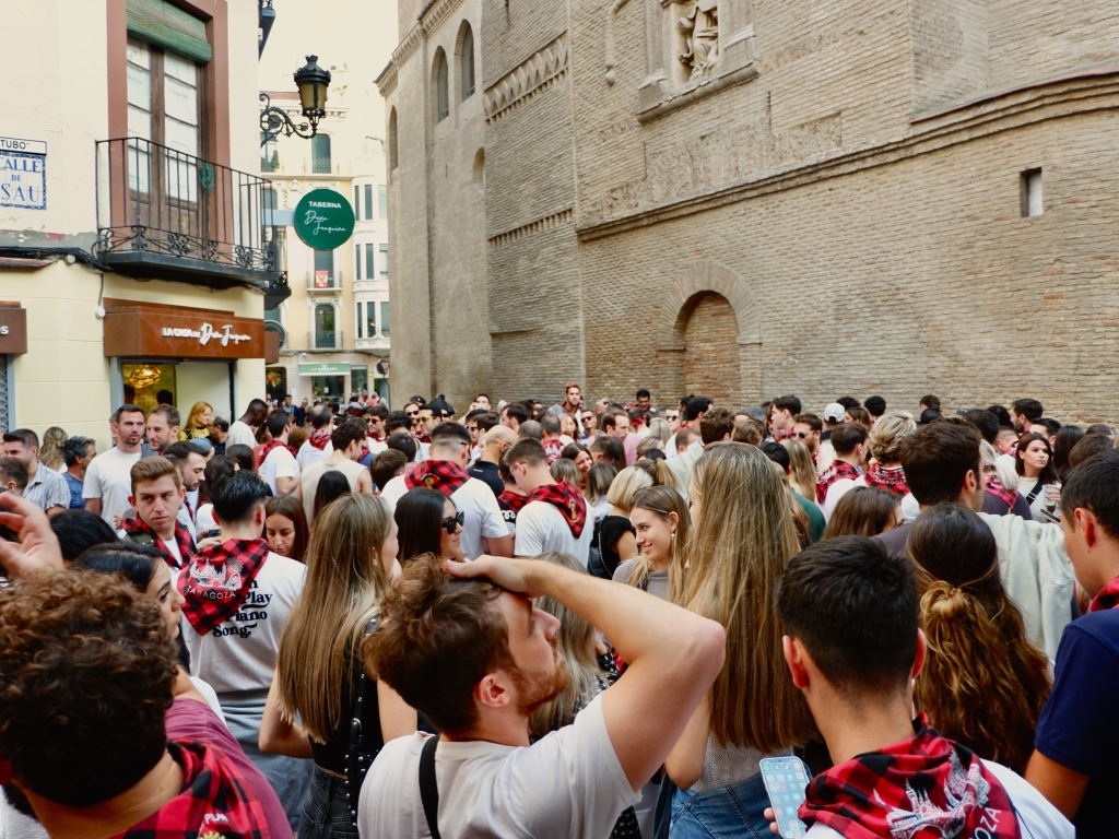 Crowd of young people with a cap celebrating the week of El Pilar