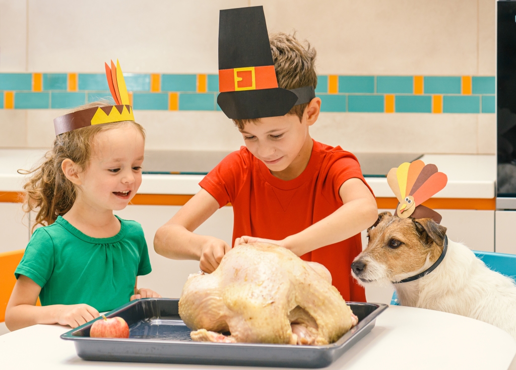 Children in Thanksgiving costumes stuffing the turkey