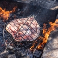 Preparing and grilling Masgouf over an open fire in the southern marshes of Iraq