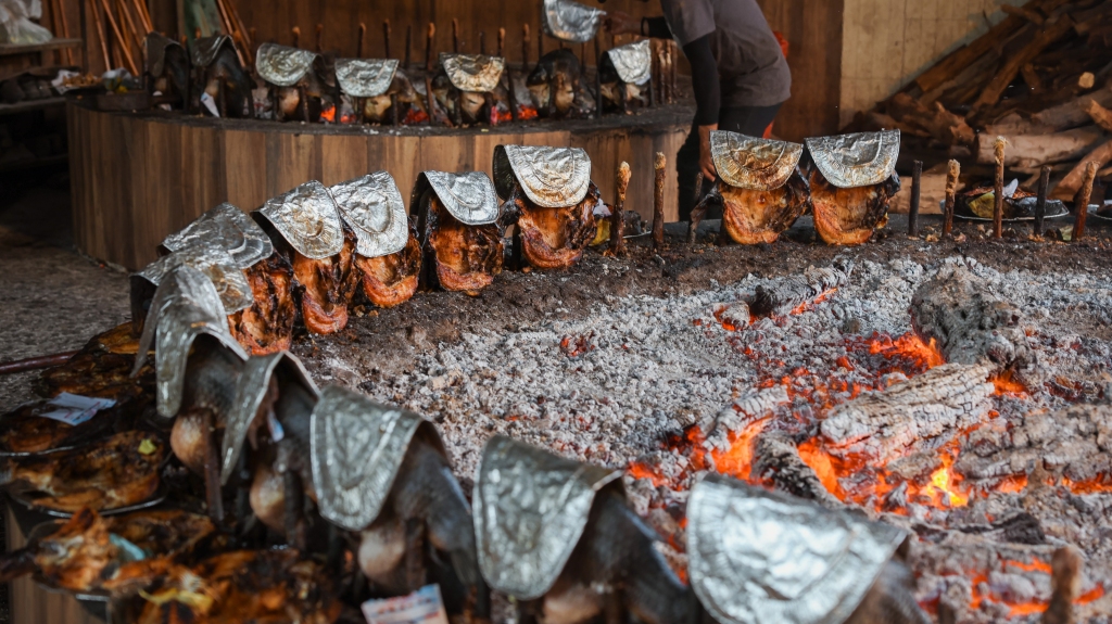 Process of roasting Masgouf fish in Irak over an open flame in a local restaurant