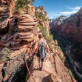 Yong female summiting to the top of Angels Landing, Zion National Park.