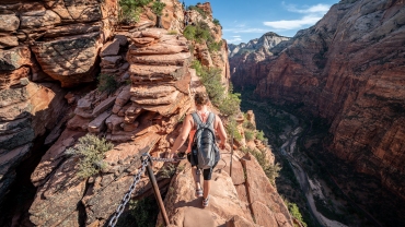 Yong female summiting to the top of Angels Landing, Zion National Park.