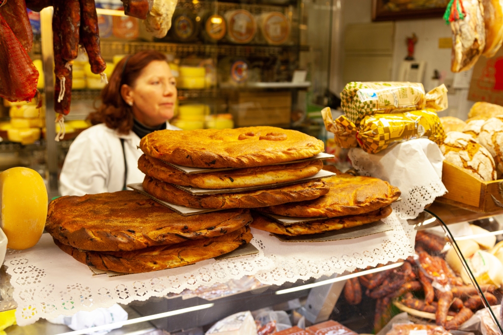 Woman in the market of Lugo, Galicia selling Galician empanadas