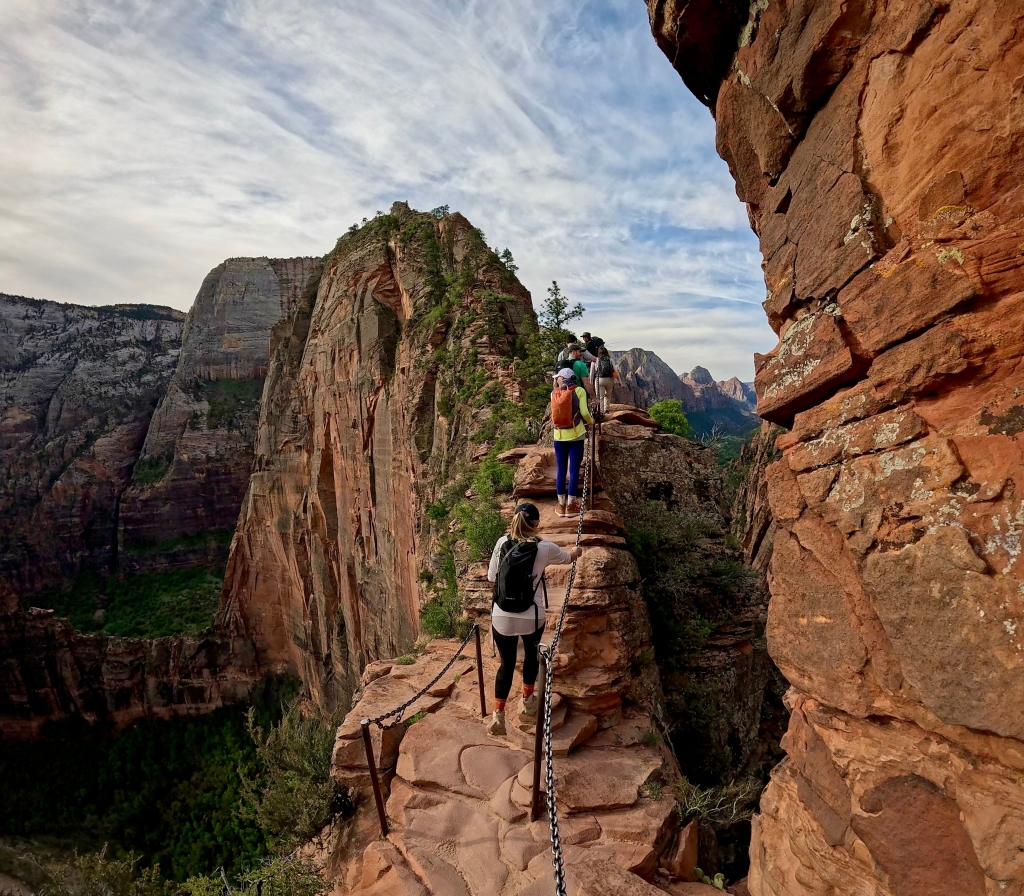 Hikers reach a foot-wide and very exposed portion of the Angels Landing Trail in Zion National Park.
