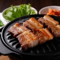 Traditional Korean barbecue Samgyeopsal with side dishes