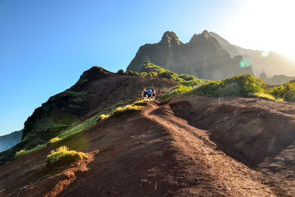 Group of young hikers in the Kalalau Valley near Kalalau Beach on the Na Pali Coast on the island of Kauai, Hawaii