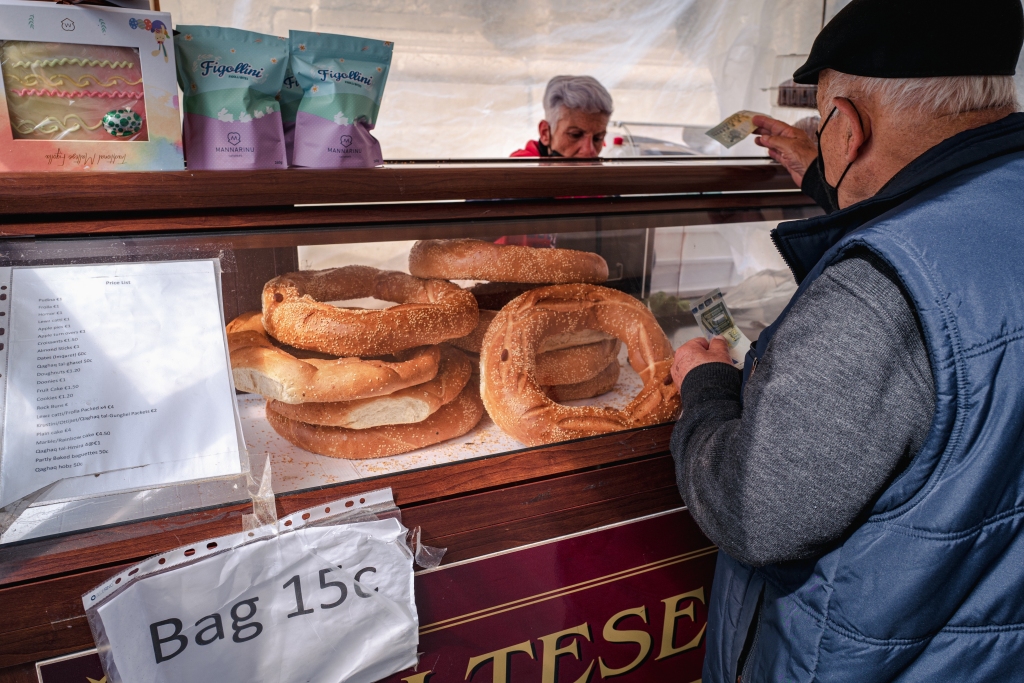 A man buys Qagħaq tal-Apostli in Valletta