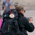 pilgrim woman capturing smartphone photos near the cathedral of santiago de compostela