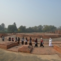 Buddhist pilgrims circumambulate the Dharmarajika Stupa in Sarnath, India