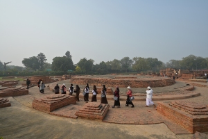 Buddhist pilgrims circumambulate the Dharmarajika Stupa in Sarnath, India