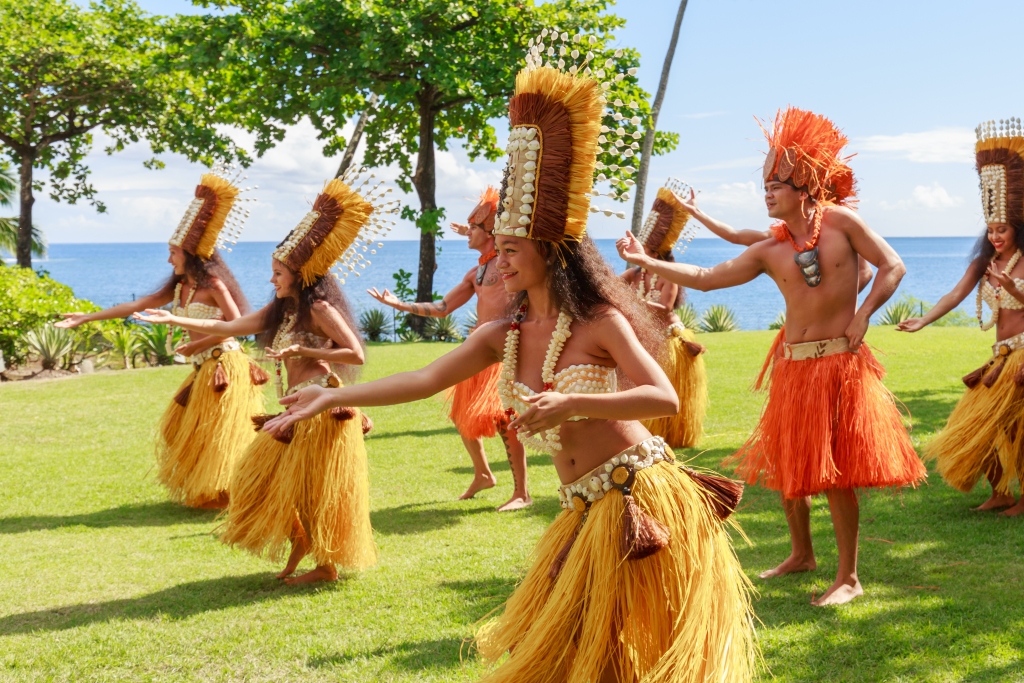 PAPEETE, FRENCH POLYNESIA - AUGUST 28, 2017: Polynesian women perform traditional dance in Tahiti Papeete. Polynesian dances are major tourist attraction of luxury resorts of French Polynesia.