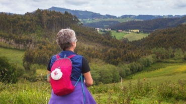 Pilgrim after a tough stage on the Camino de Santiago, enjoying the scenery of northern Spain, Asturias