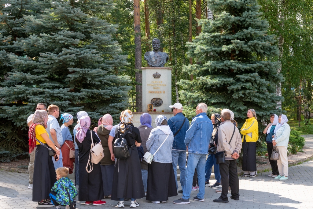 Tourists and pilgrims at the monument to Emperor Nicholas II at the site of his execution in Yekaterinburg