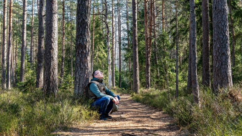 A man experiencing silence in nature