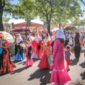 A parade of people wearing traditional costumes in the San Isidro festival