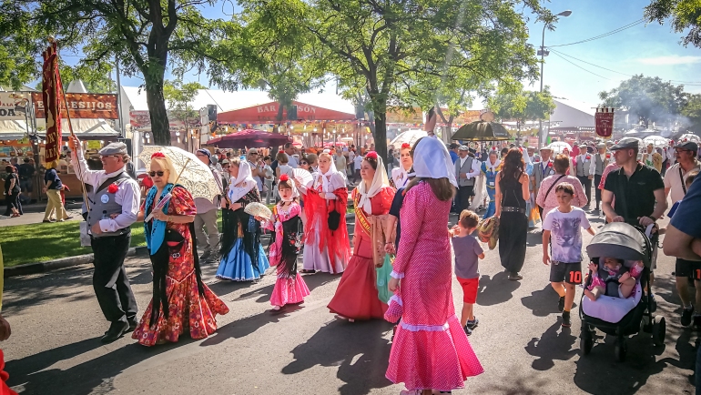 A parade of people wearing traditional costumes in the San Isidro festival