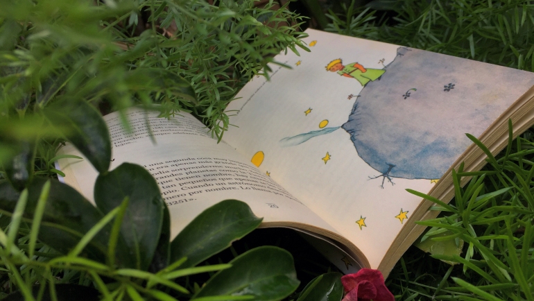 Open book “Little Prince” by Antoine De Saint-Exupéry