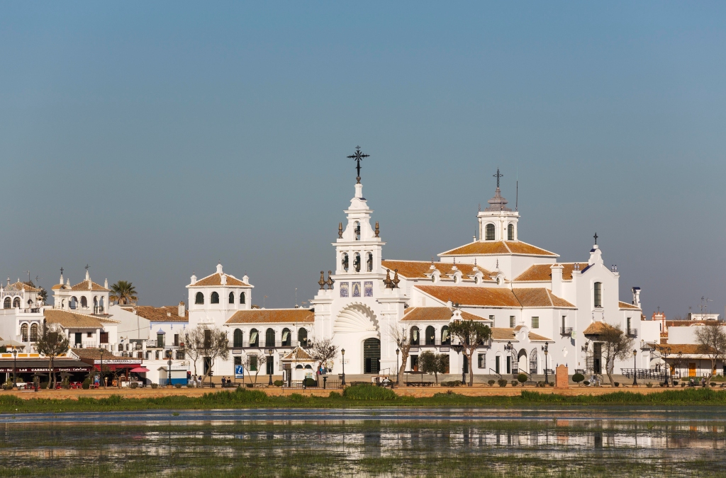 El Rocío village with the Hermitage of El Rocío, in the Madre de las Marismas del Rocío reservoir, Doñana National Park