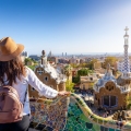A female tourist enjoys a sightseeing trip through the popular Park Güell in Barcelona, ​​Spain, on a sunny day