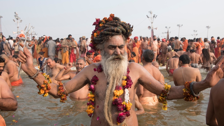 Hindu holy men and pilgrims takes a dip during the Shahi Snan (grand bath) at kumbh mela in Allahabad Uttar Pradesh India