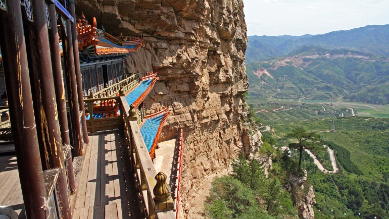 Taoist temple carved in rock with large vistas of space below in Henshan Bei