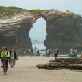 Visitors exploring Cathedral Beach at low tide