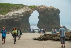 Visitors exploring Cathedral Beach at low tide