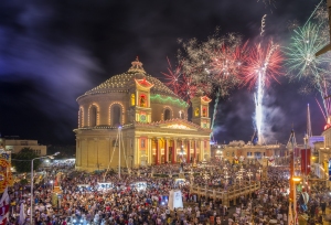 Fireworks at the Mosta festival at night with the famous Mosta Dome and the People of Malta are celebrating the Feast of the Assumption of 'Santa Maria'.
