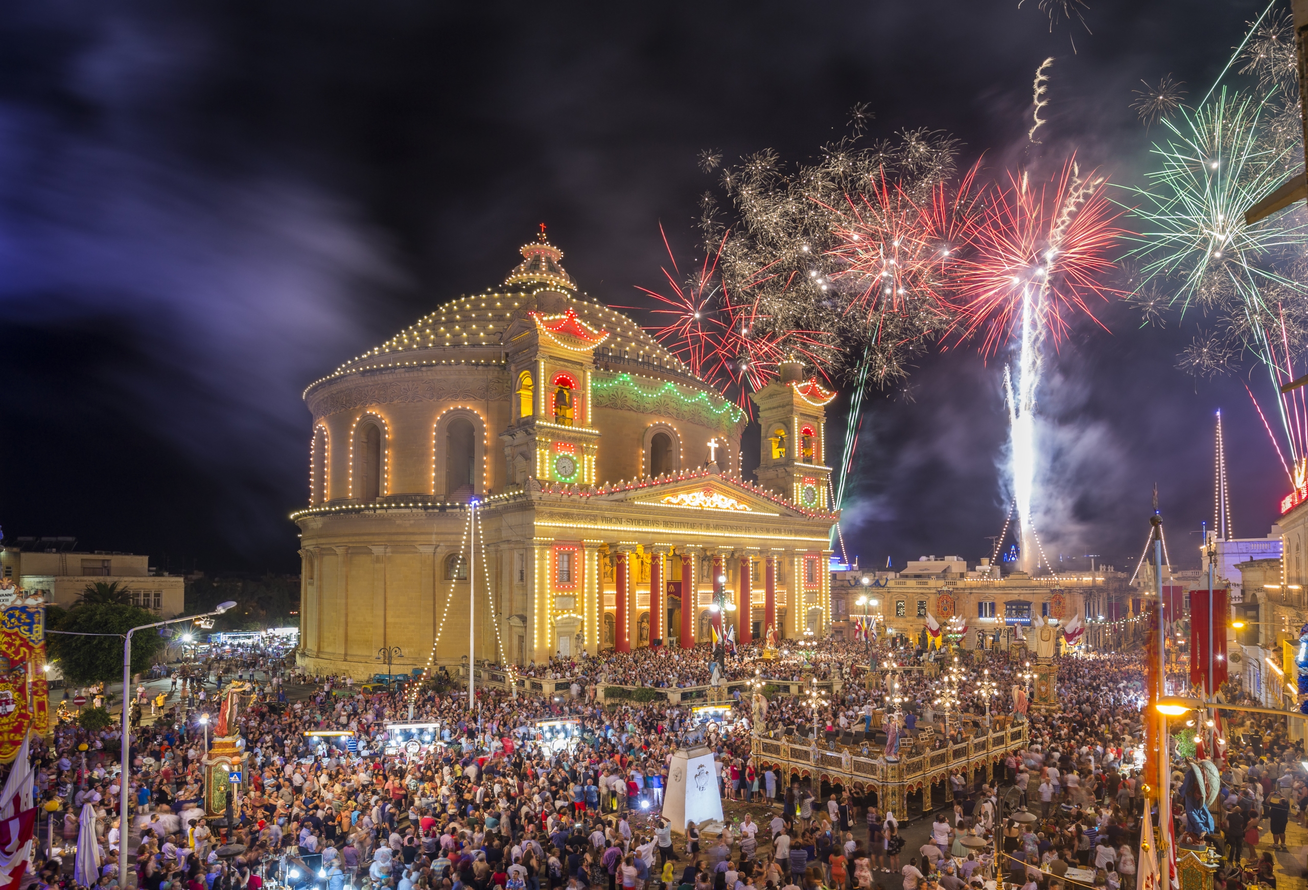 Fireworks at the Mosta festival at night with the famous Mosta Dome and the People of Malta are celebrating the Feast of the Assumption of 'Santa Maria'.