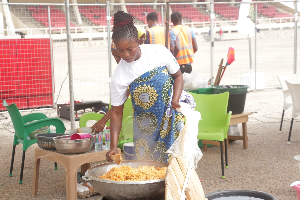 A lady preparing Jollof rice for an event in Ghana