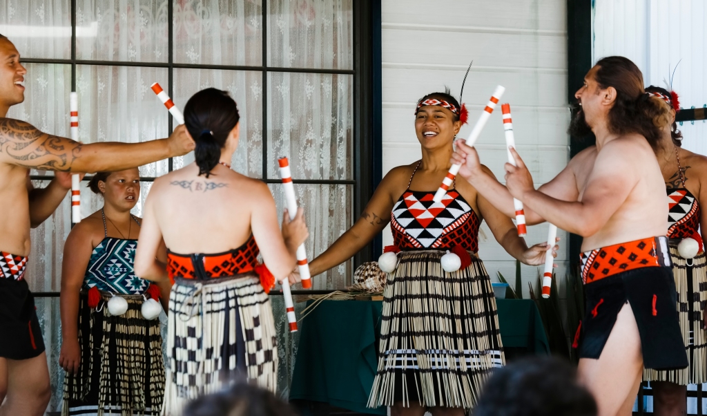 Maori group singing and dancing with stick in Rotorua, New Zealand.